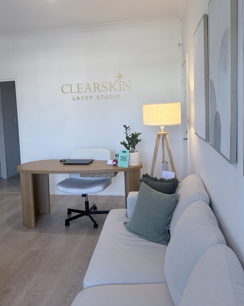 The ClearSkin studio in Oxenford: consult desk, lounge and gold logo wall